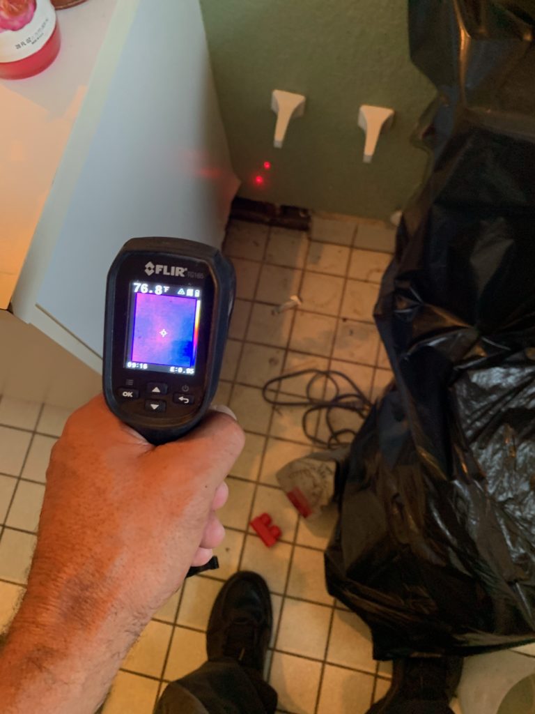 laser moisture meter indicates water behind home walls